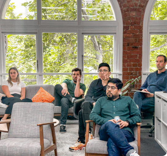 Sonar employees attending the monthly consulting workshop and actively listening to key speakers